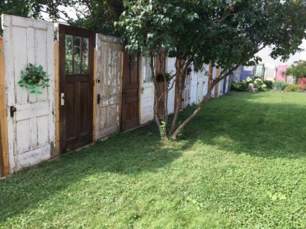 A yard FENCE made out of DOORS